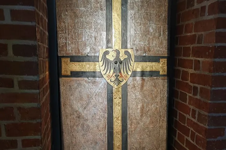 Close-up of a decorated door featuring a black eagle crest.